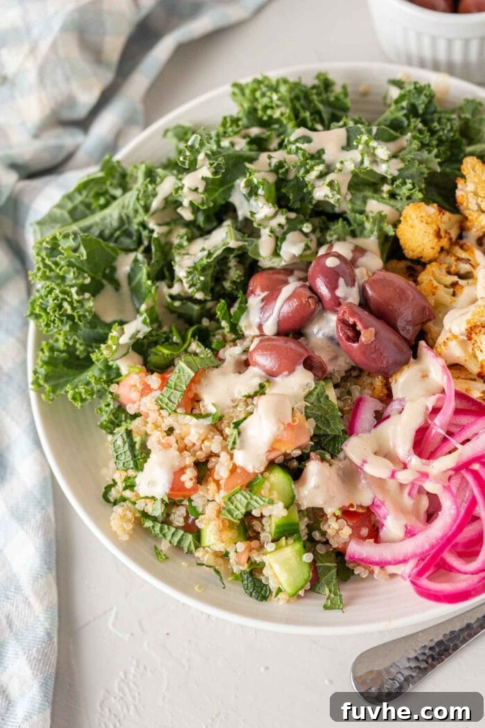 Mediterranean Cauliflower Power Bowls 7 A bright bowl of healthy ingredients pickled onions, cauliflower, quinoa, kale and olives.