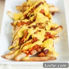 Ultimate Vegan Chili Cheese Fries 11 A plate of baked fries topped with chili and cheese sauce.