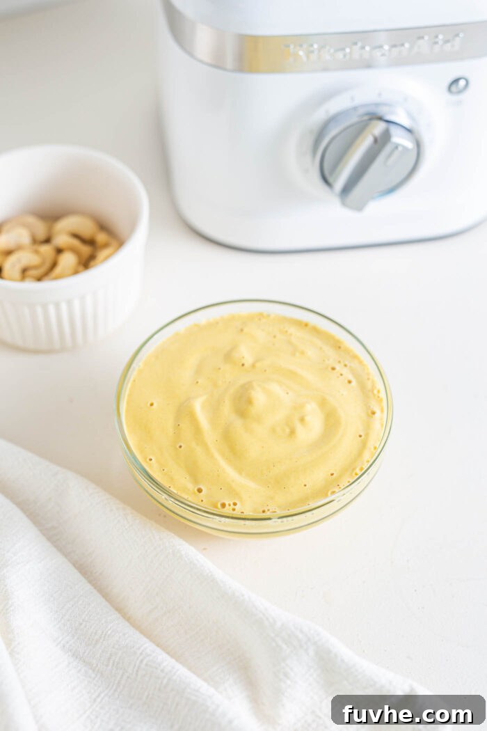 Ultimate Vegan Chili Cheese Fries 8 Creamy vegan cheese sauce in a small glass bowl.