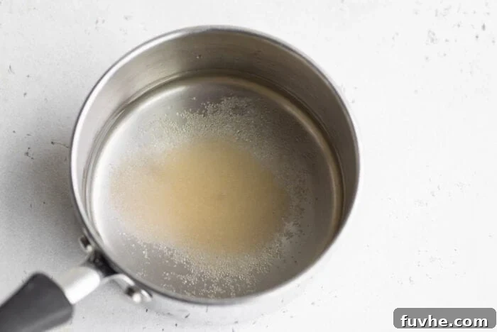 White vinegar, water, and sugar combined in a small saucepan, ready to be boiled.