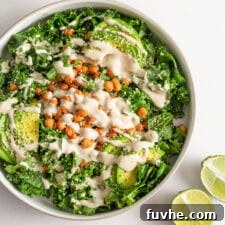 Overhead view of a salad with roasted chickpeas, avocado and a creamy dressing.