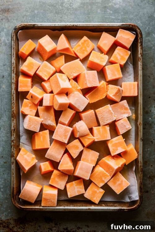 Velvet Sweet Potato Sip 4 Chopped sweet potato cubes on a baking sheet.