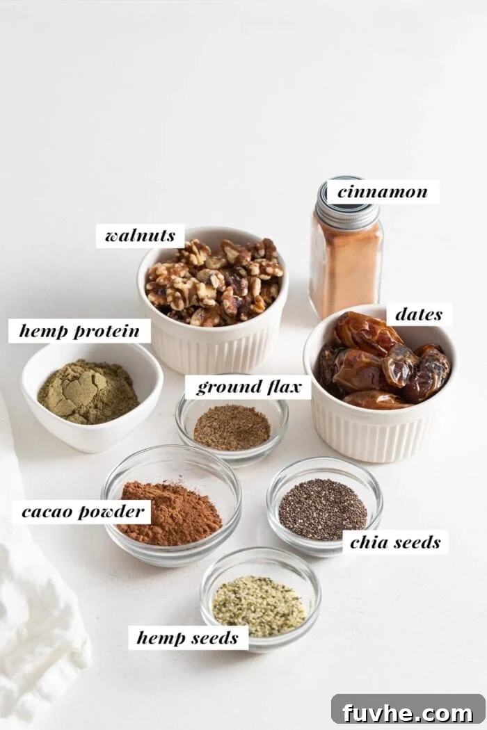 Dates, walnuts, cocoa powder, cinnamon, hemp seeds, protein powder, ground flax and chia seeds in small glass bowls, each ingredient labelled is with text overlay.