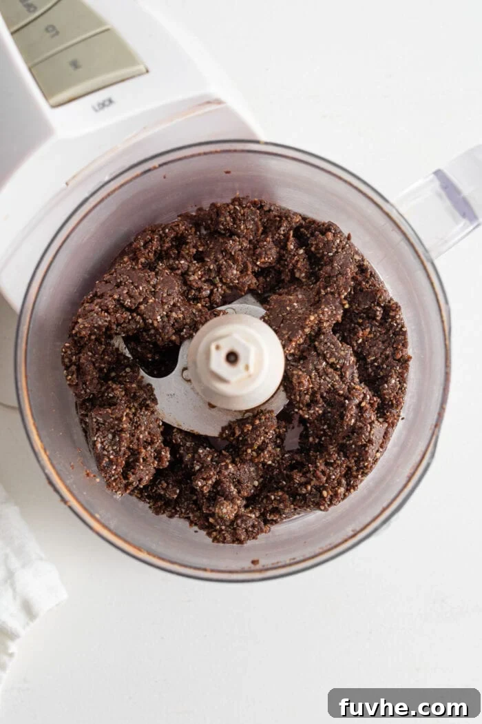 Chocolate energy ball dough in a food processor.