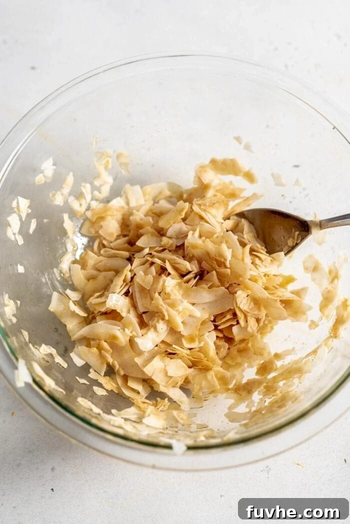 Smoky Coconut Crisps 5 Raw coconut bacon in a glass bowl.