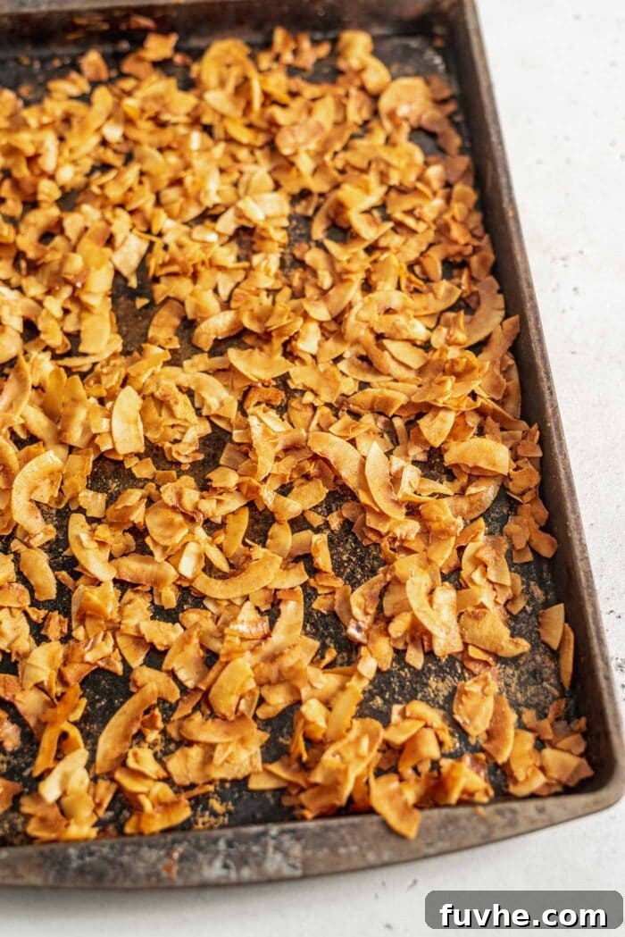 Smoky Coconut Crisps 6 A baking tray full of golden brown coconut bacon.