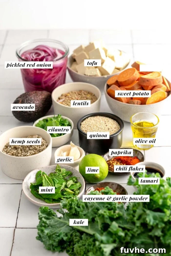 All of the ingredients needed for making a sweet potato quinoa tofu bowl with kale, avocado and hemp seed dressing.