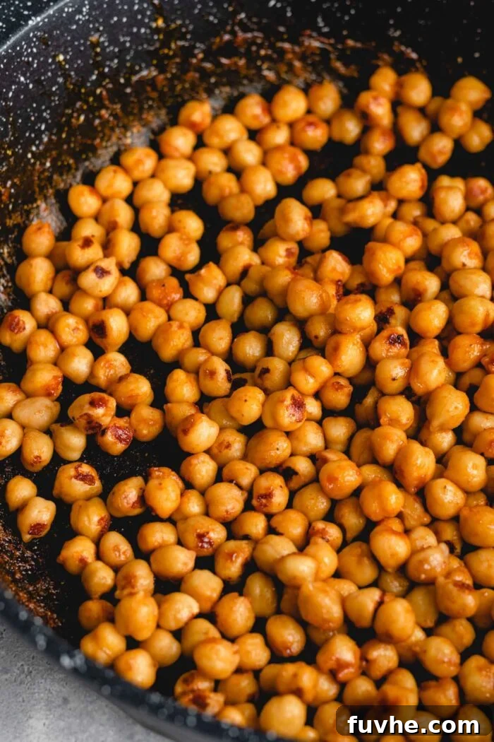 Smoky Vegan BBQ Chickpea Salad 4 Gooey and browned BBQ chickpeas cooking in a skillet.