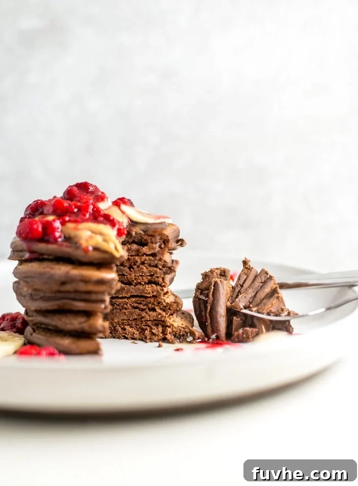 A close-up of thick gluten-free vegan protein pancakes, perfectly cooked and ready to be served.