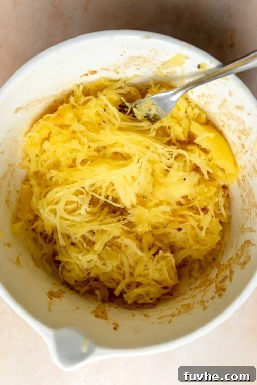 Spaghetti squash noodles in a bowl with a spoon.