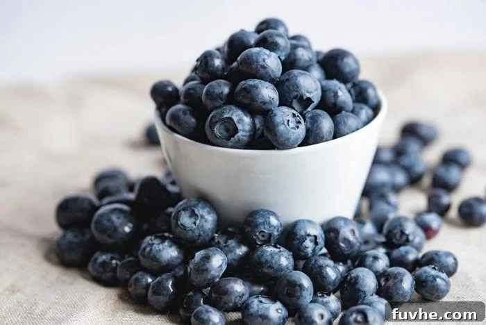 The Ultimate Vegan Macro Cheat Sheet 4 A crisp image of fresh blueberries in a pristine white bowl, highlighting their natural allure and vibrant color.