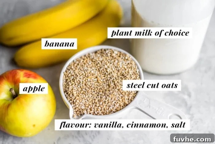 Steel cut oats in a measuring cup beside an apple, banana and jar of plant-based milk. Key ingredients for healthy baked oatmeal.