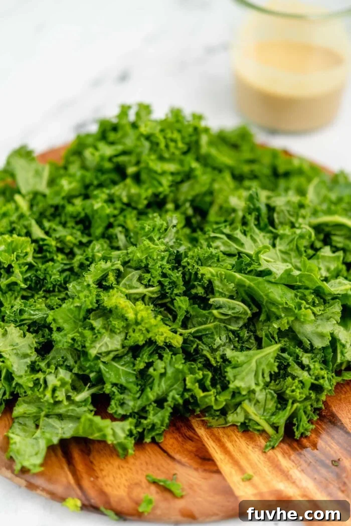 Wholesome Vegan Carb-Conscious Bowls 10 Finely chopped kale leaves laid out on a cutting board, ready for massaging.