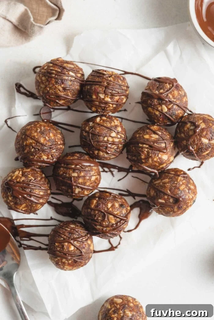 Snack Smarter: 31 Plant-Based Bites 3 A number of no-bake energy balls drizzled in chocolate on a piece of parchment paper.