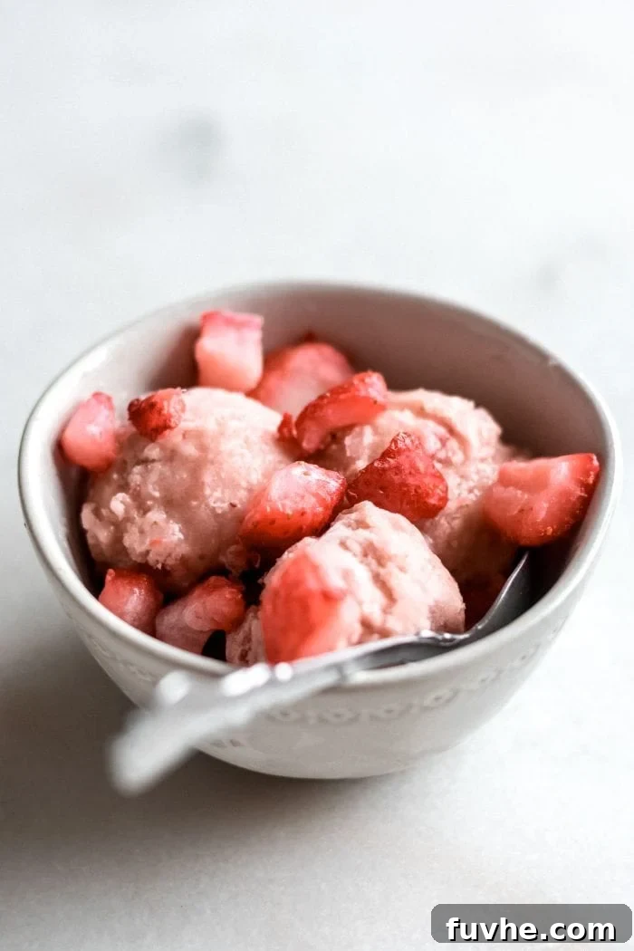 Snack Smarter: 31 Plant-Based Bites 10 Bowl with 3 scoops of vegan strawberry banana ice cream and fresh strawberries.