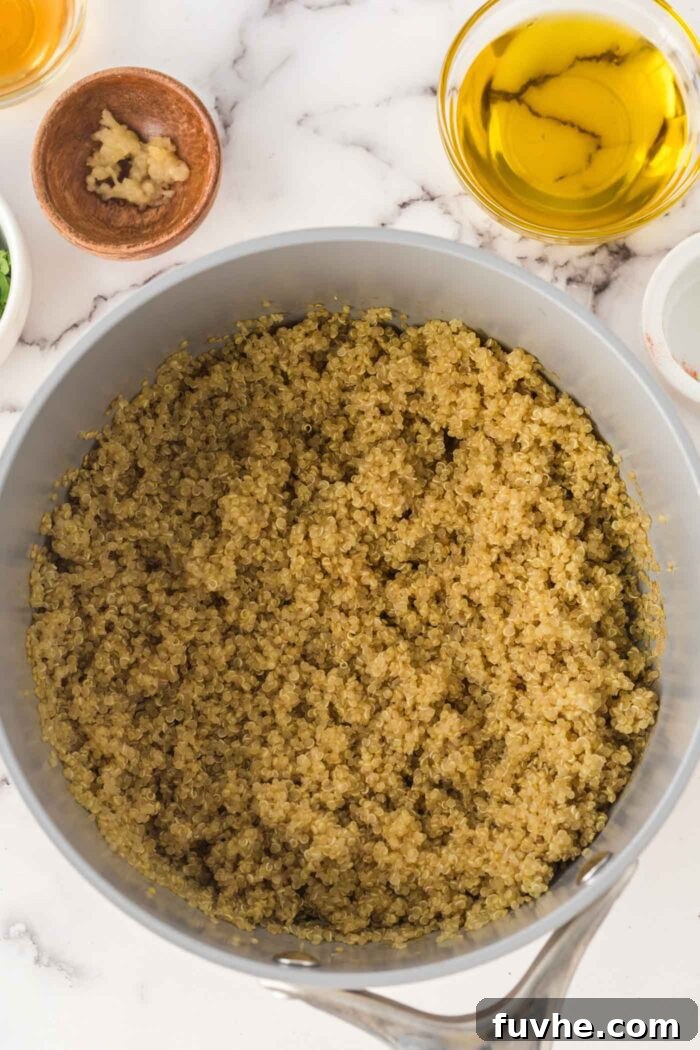 Freshly cooked quinoa resting in a pot, ready to be fluffed.
