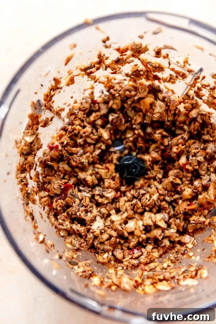 The vegetarian taco 'meat' mixture, made from mushrooms and walnuts, seasoned with chipotle, ketchup, and spices, combined in a food processor.