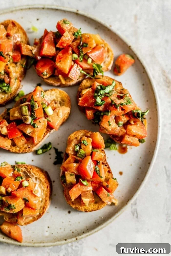 Pieces of vegan bruschetta on a plate, garnished with fresh basil.