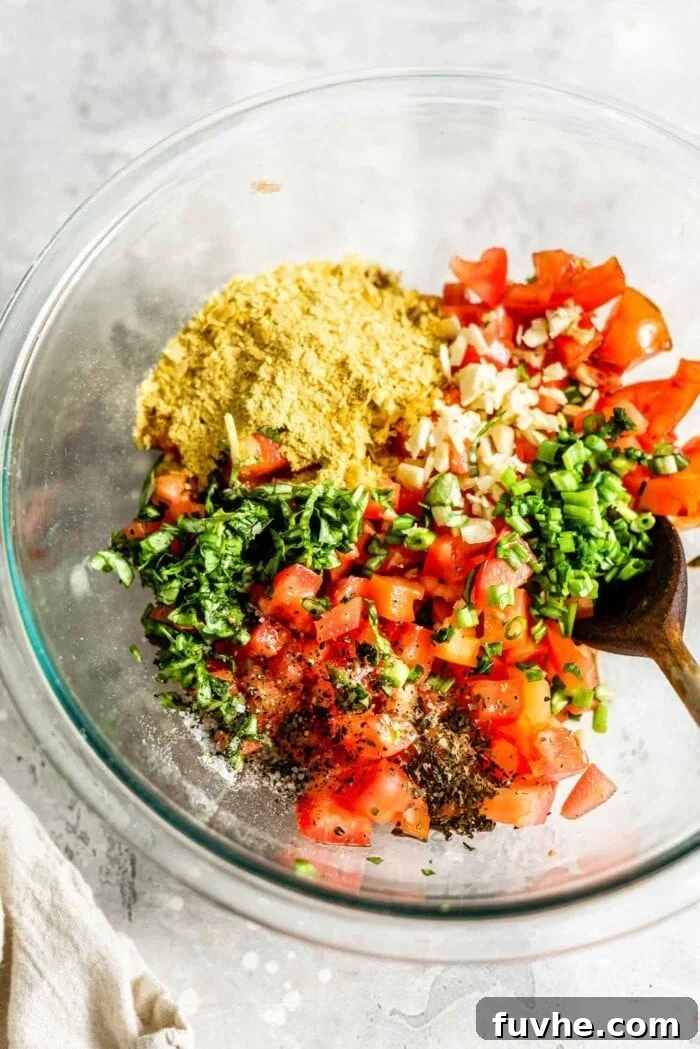 Vegan bruschetta ingredients in a mixing bowl, marinating.