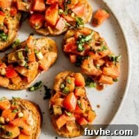 Pieces of vegan bruschetta on a plate, ready to be served.