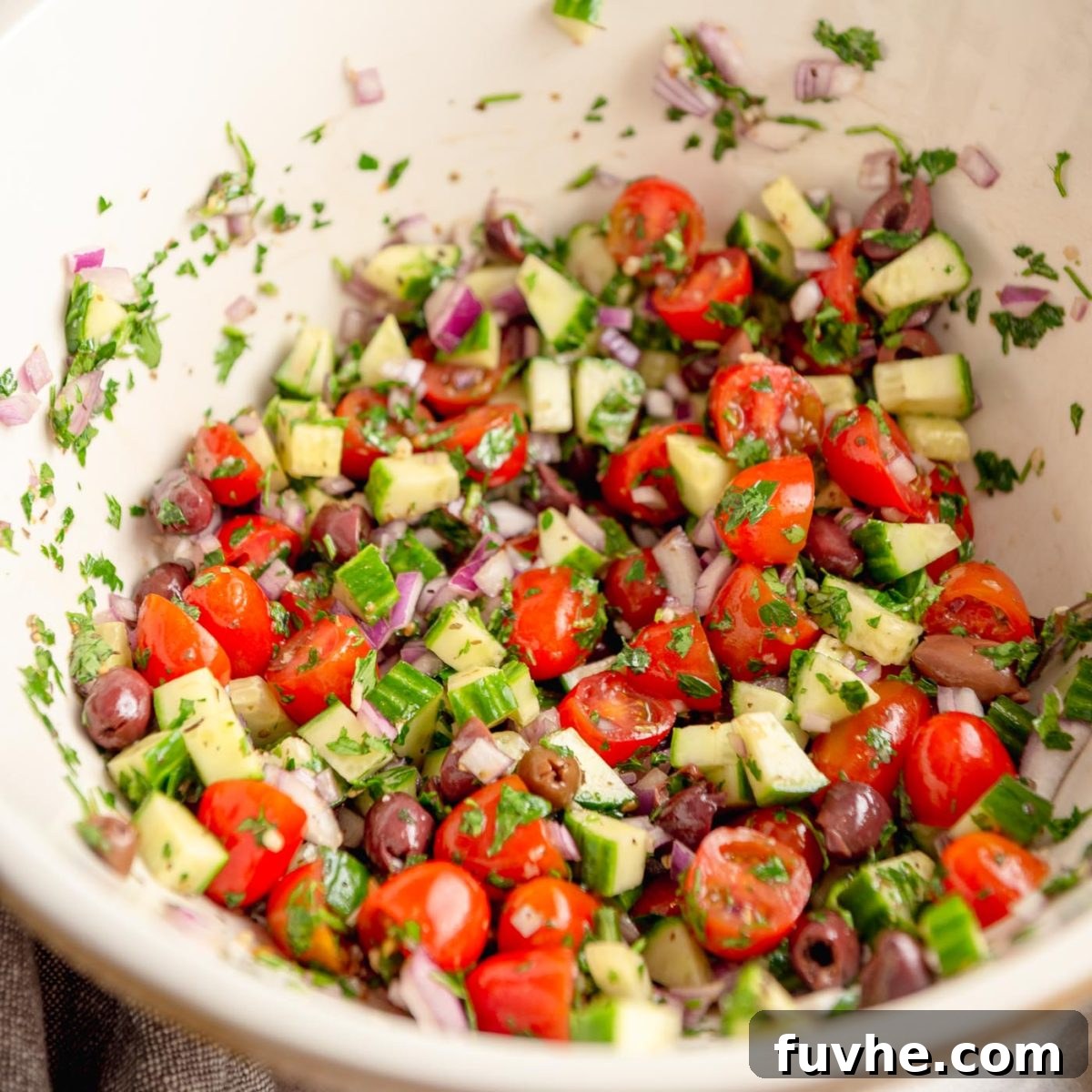 Plant-Based Greek Pasta Salad 6 Chopped tomatoes, cucumber, olives, red onion in a large mixing bowl.