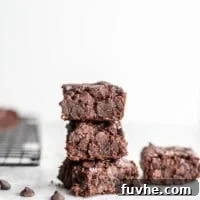 Stack of 3 vegan oat flour brownies, a close-up showing the rich, dark chocolate and soft texture.