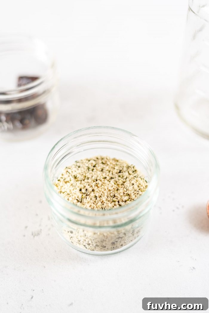Small glass mason jar filled with hemp seeds.