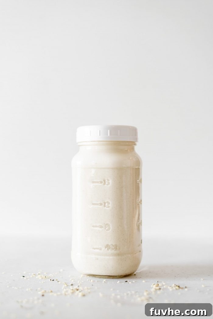 A sealed glass jar of homemade hemp milk.