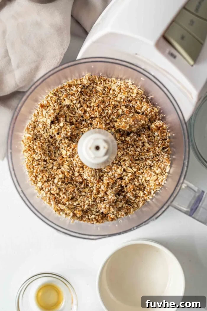 All ingredients blended into a thick, sticky dough within a food processor, ready for pressing.