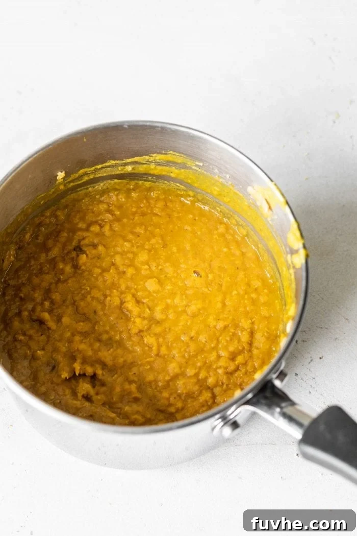 Golden Lentil Curry Bowl 3 Curried red lentils in a small saucepan.