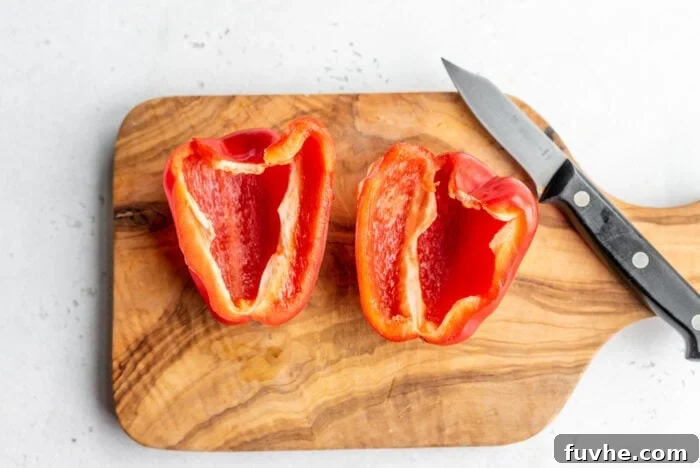 Perfect Roasted Peppers 4 A red bell pepper half on a cutting board, with all seeds and internal membranes neatly removed.