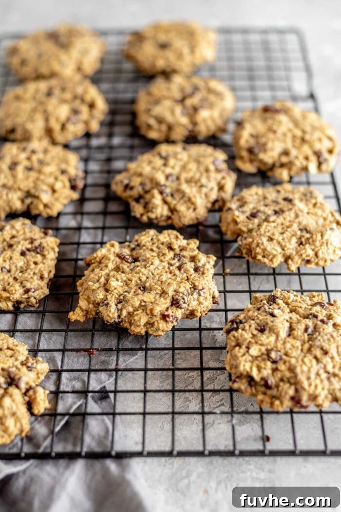 Healthy oat cookies sitting on a cooling rack, allowing them to set and achieve their perfect texture.