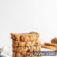 Stack of 5 slices of easy vegan banana bread on a white plate.