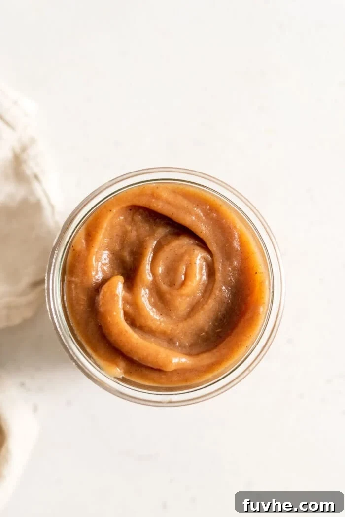 Overhead image of apple butter in a glass jar.