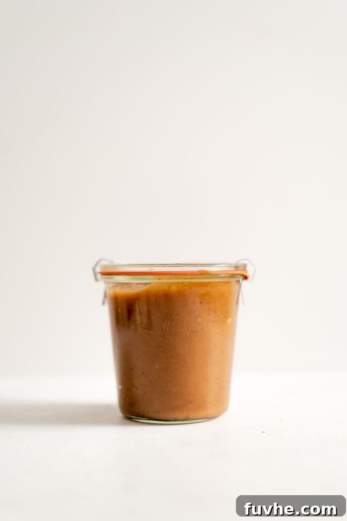 A sealed glass jar of apple butter.