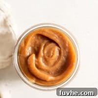 Overhead image of apple butter in a glass jar.