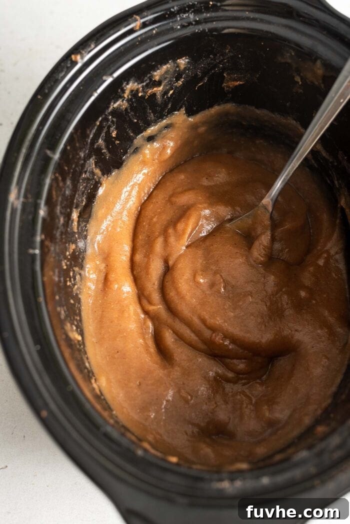 Thick apple butter in a slow cooker.