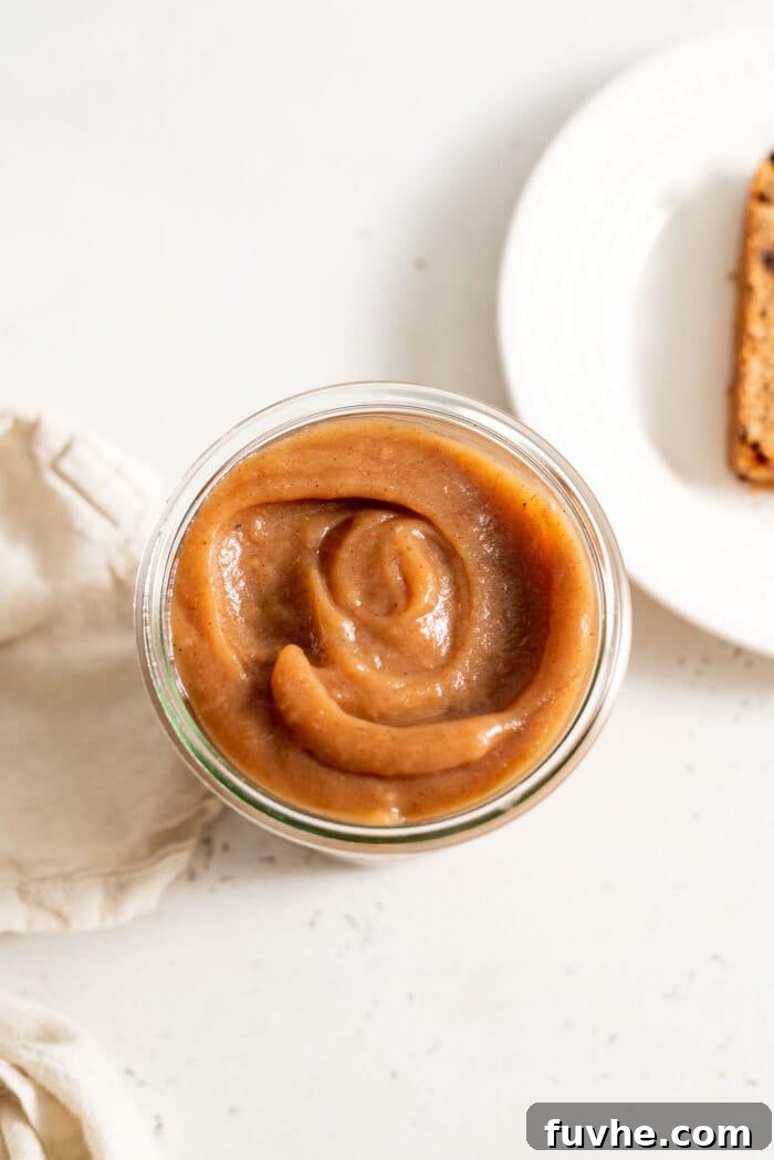 Thick apple butter in a glass jar.