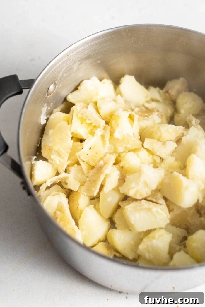 Cooked chopped potatoes in a large stockpot.