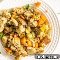 Plant-based stuffing made with cubed bread and vegetables on a small plate.