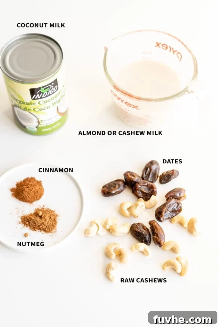 Festive Vegan Nog 3 Arrangement of ingredients including plant milk, cashews, dates, and spices for vegan eggnog.
