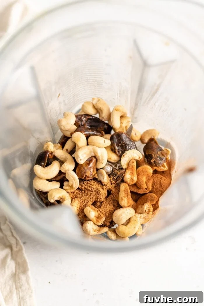 Festive Vegan Nog 4 Raw cashews, dates, nutmeg, and cinnamon ready to be blended for vegan eggnog.