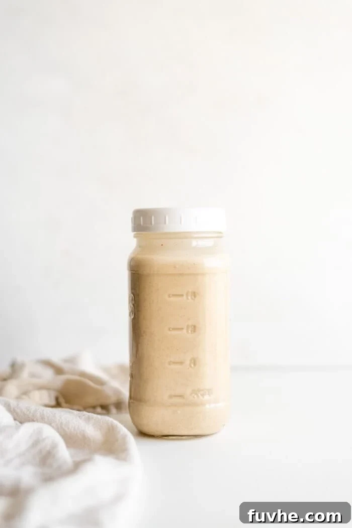 Festive Vegan Nog 7 Smooth and creamy vegan eggnog in a glass jar with a white lid.