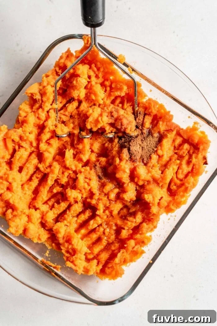 Golden Vegan Sweet Potato Comfort 7 Mashed sweet potato with maple syrup in a baking dish.