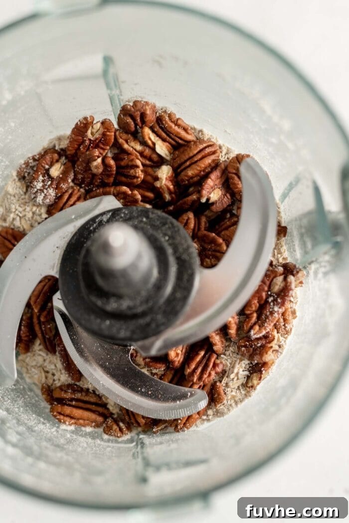 Golden Vegan Sweet Potato Comfort 8 Oat flour and pecans in a food processor.