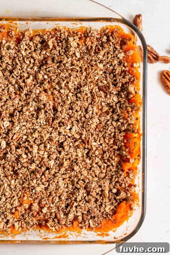 Golden Vegan Sweet Potato Comfort 10 Pecan and oat sweet potato casserole in a baking dish.