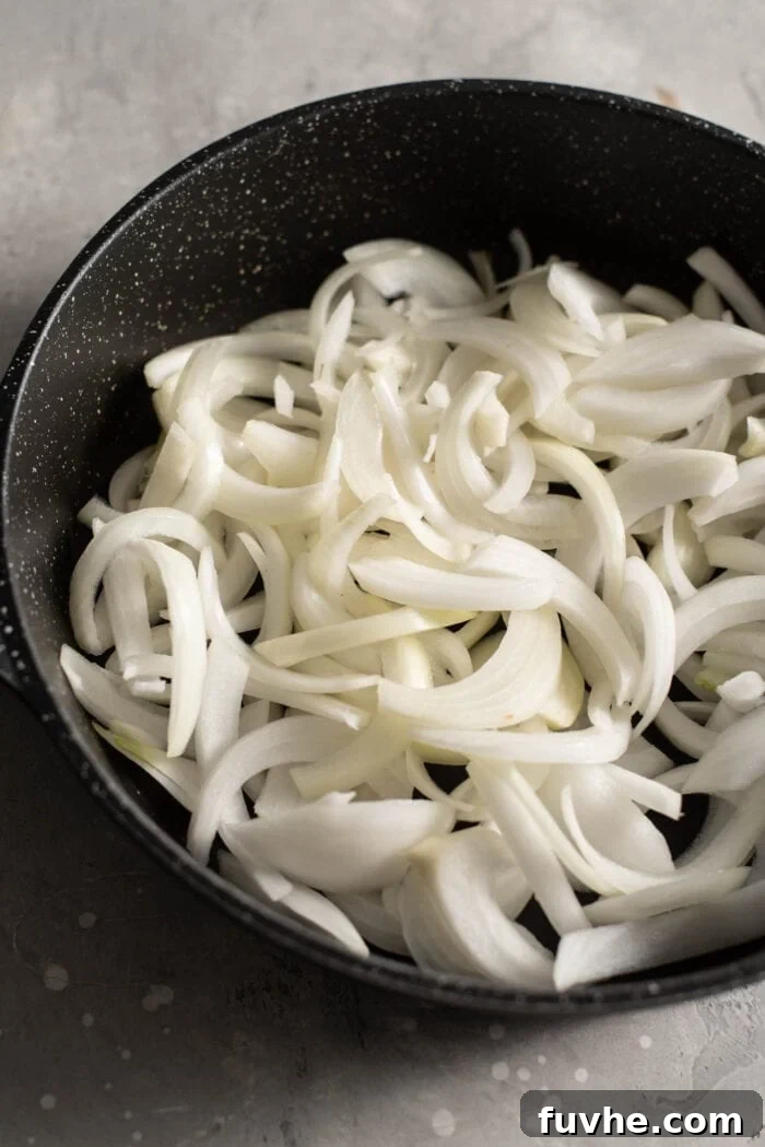 Garlicky Onion Green Bean Sauté 4 Chopped onions in a black skillet.