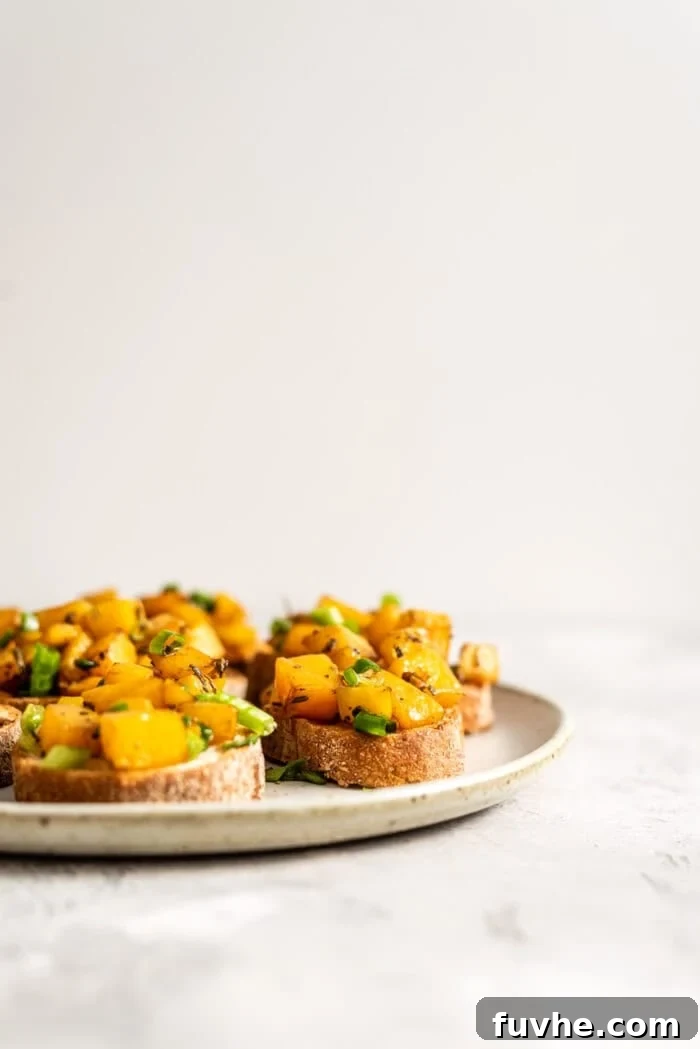 Roasted Butternut Crostini 3 Two plates of golden butternut squash bruschetta artfully arranged.