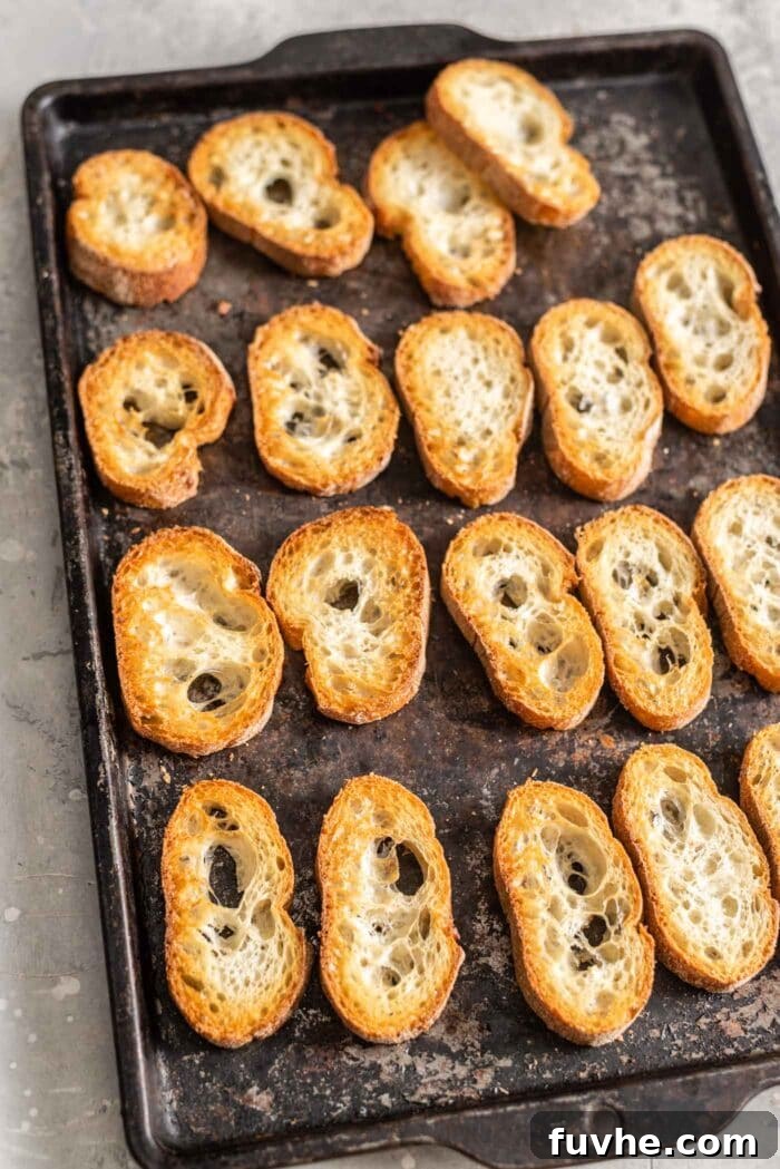Roasted Butternut Crostini 5 Lightly toasted baguette slices on a baking tray.