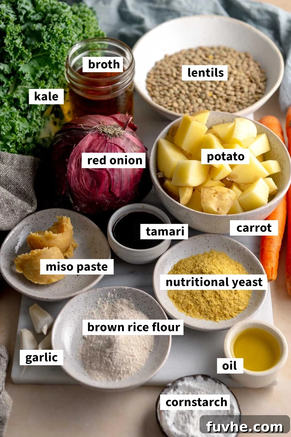 Vegan Lentil Power Bowl 3 All the fresh ingredients laid out for making a vegan lentil nourish bowl, including lentils, various chopped vegetables, and miso paste for the gravy.